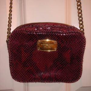 Michael Kors red snakeskin cross body purse.